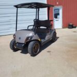 2025 Yamaha Drive2 PTV gas golf car with QuieTech EFI engine, independent rear suspension, bronze wheels, and sleek gray body, for sale at Northern Hills Golf Cars in Spearfish, SD.